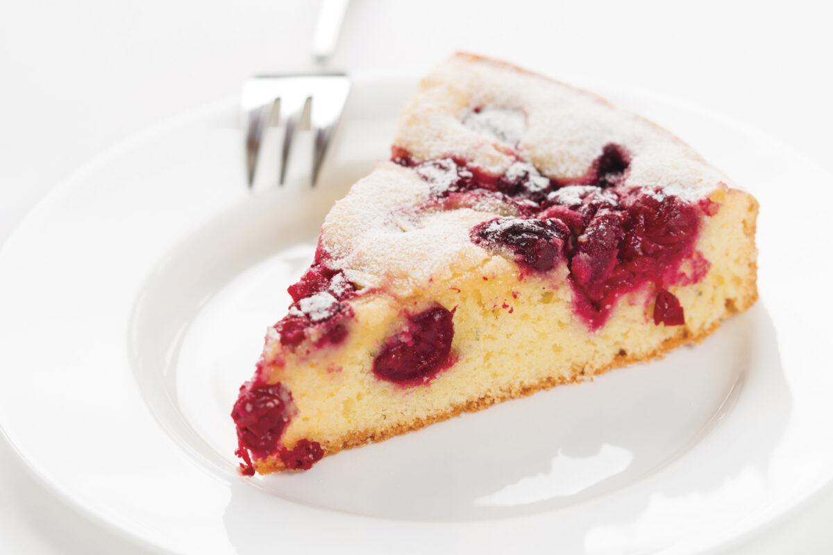 plate with a slice of cherry clafoutis, a cherry pie dessert