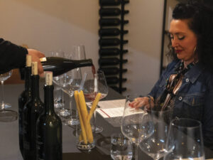 Woman sitting at counter enjoying a wine tasting experience