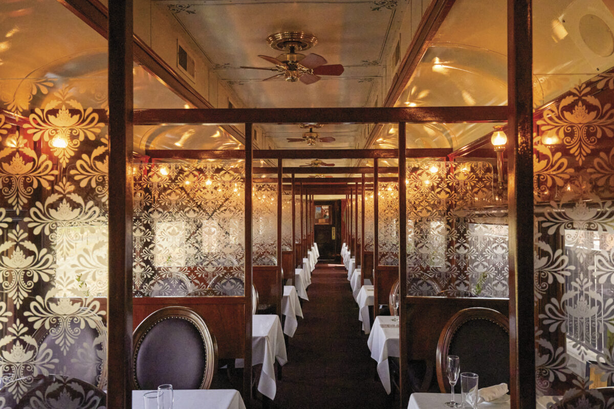 Interior of Napa Wine Train with chairs, tables with tablecloths, glass partitions