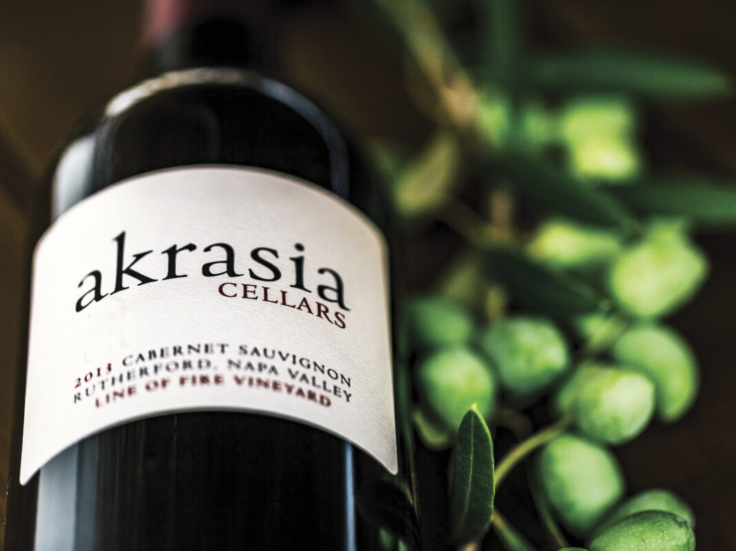 Image of bottle of Akrasia wine in front of greenery