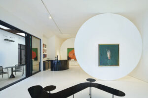 Interior of art gallery with art on white walls with white floors