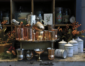 selection of copper dishes and serving pieces on display in a store