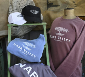 display of baseball hats, tee shirts and sweatshirts with Napa Valley lettering on them in white