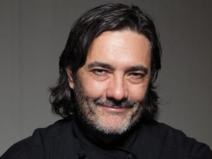 15 time Michelin Star Chef Stefano Masanti in his V. Sattui Winery black Chef Coat wtih gray background