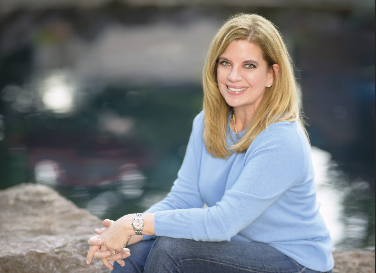 Jeri Hansen seated outdoors wearing a blue sweater and jeans