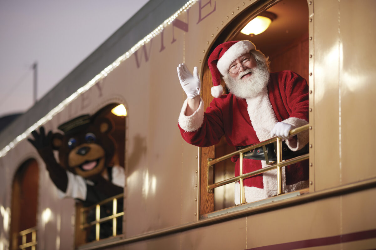 santa claus and person dressed in bear suit waving out the window of a train car - part of the Napa Valley Wine Train