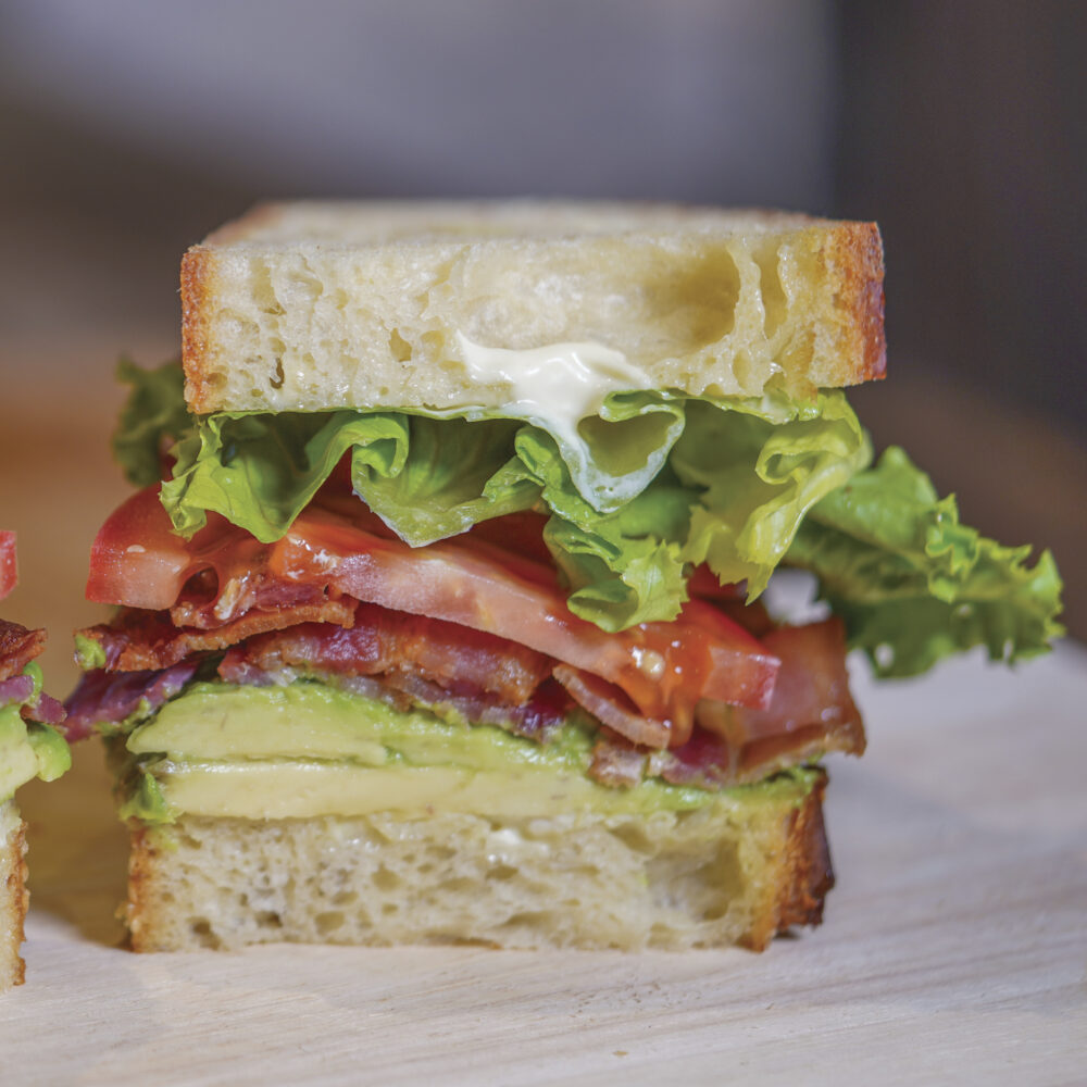 sandwich with lettuce, tomato, avocado, mayonnaise and meat