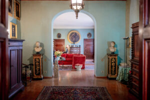 Palazzo Jacobini Foyer - showing antiques, marble busts, old-world art, a red couch