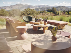 Outdoor patio at Chandon California with modern patio furniture on wood dech with mountain in background