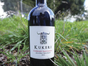 bottle of Kukeri wine outside on greenery