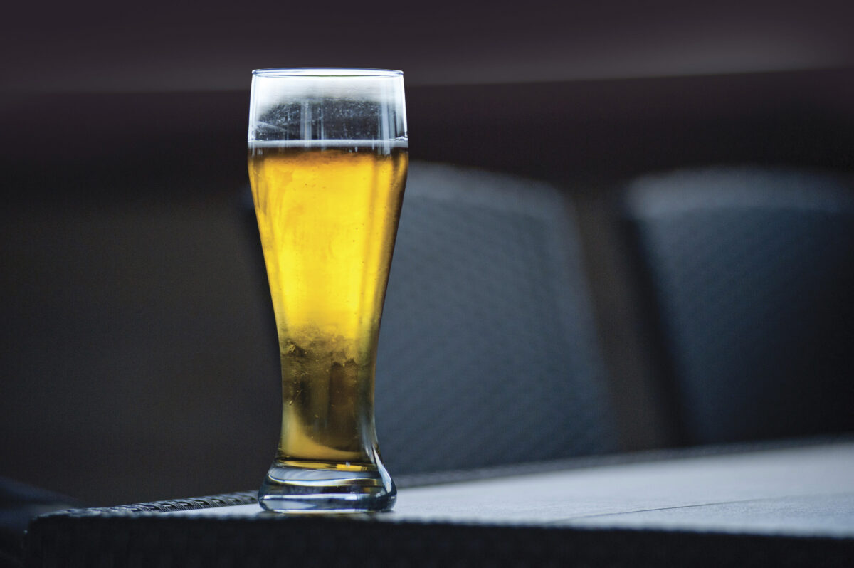 glass of beer on dark table with dark background