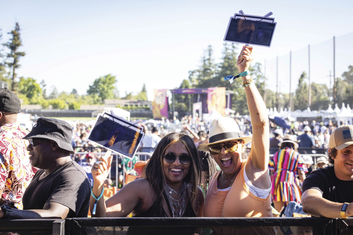 outdoor music festival goes in crowd, smiling