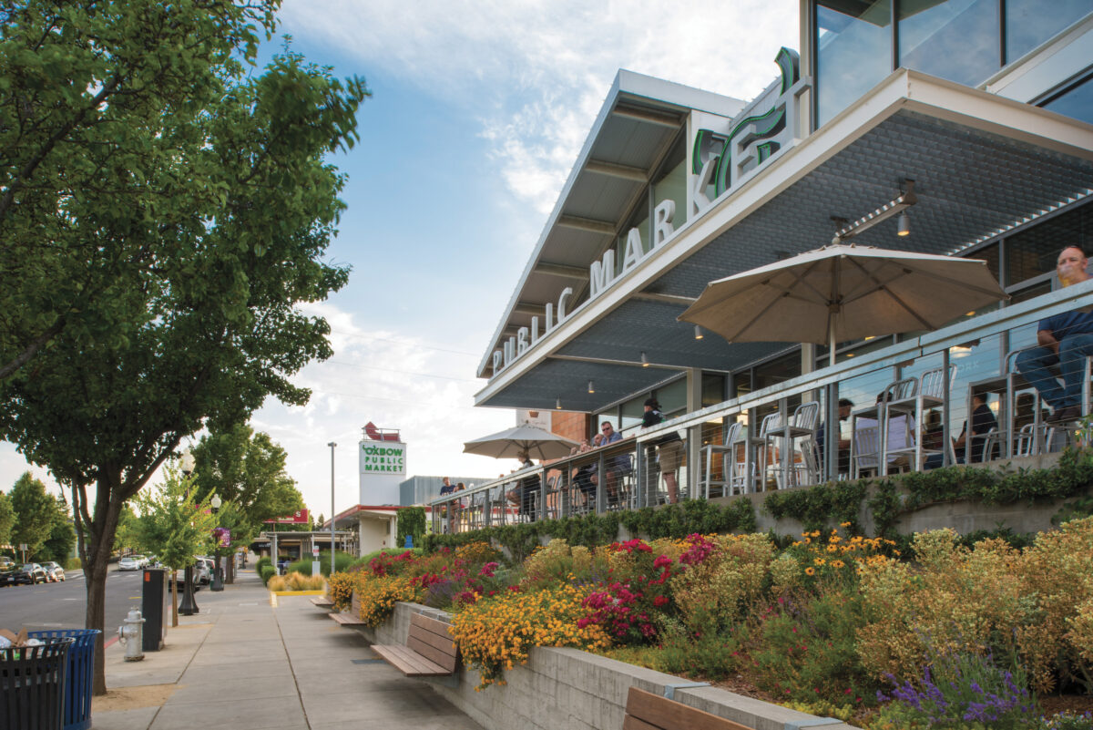 exterior view of Oxbow Public Market building with colorful plants out front