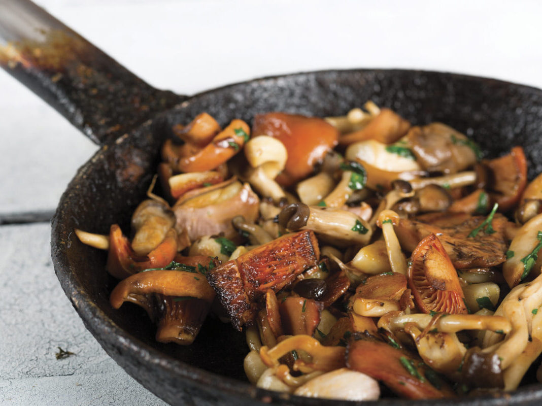 Sauteed wild mushrooms in black cast iron skillet