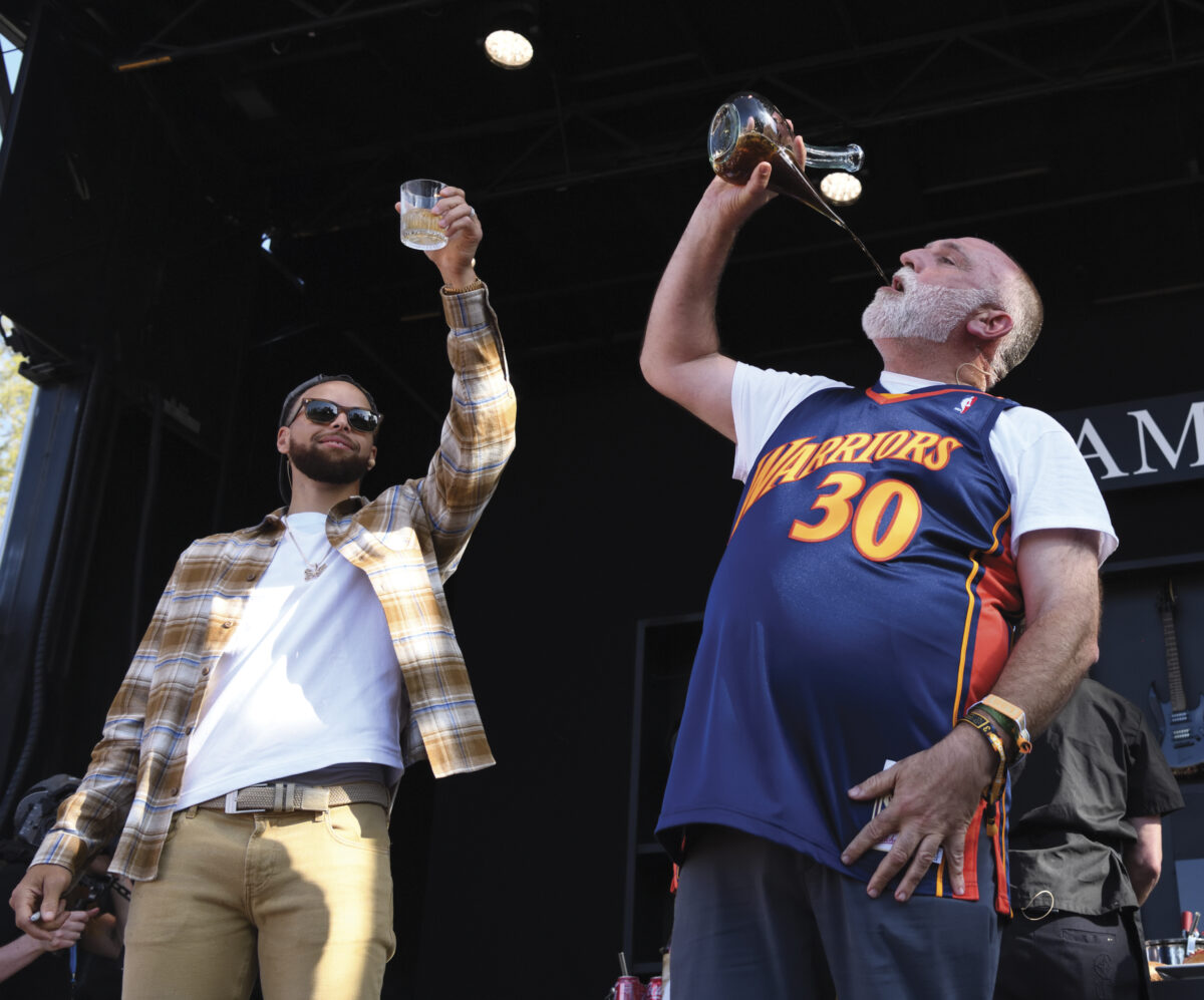 NBA Superstar Steph Curry and Chef Jose Andres on stage with arms up