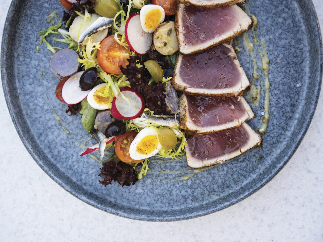 salad and tuna on blue plate on table