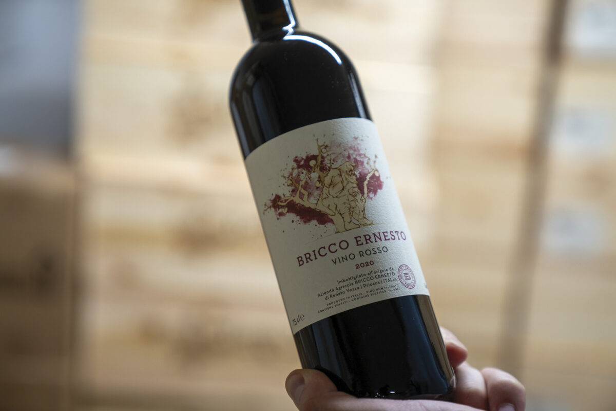 person holding a bottle of wine with label saying Bricco Ernesto for the article Piedmont's Bounty