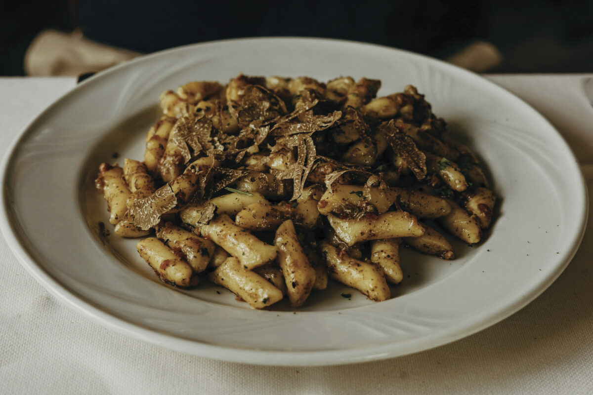 plate of pasta with truffles on white table for the article "Amuse Bouche"