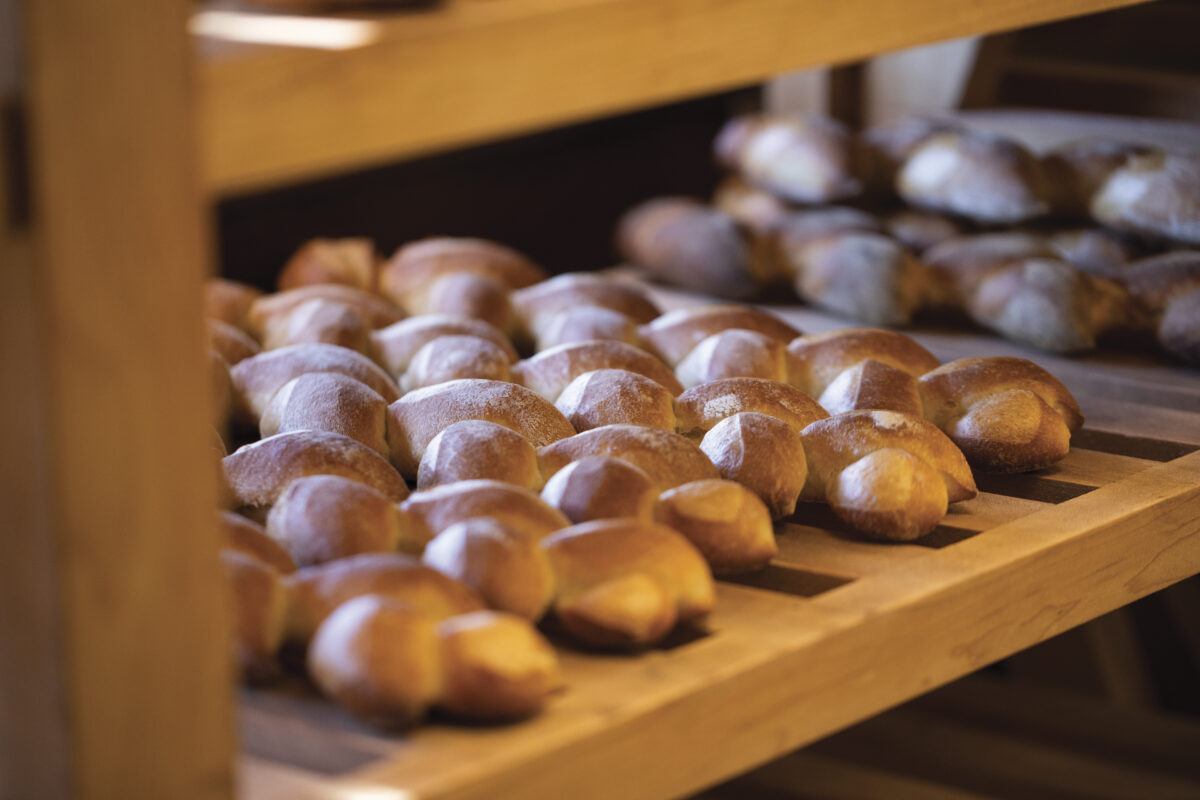 rows of baked goods cooling on wooden shelf