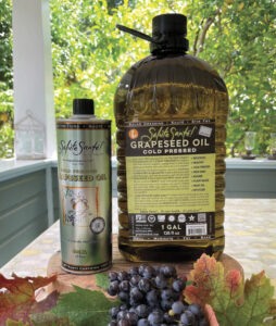 Salute Sante display on outdoor patio table with grapes and leaves in foreground for the article Holiday Gift Guide