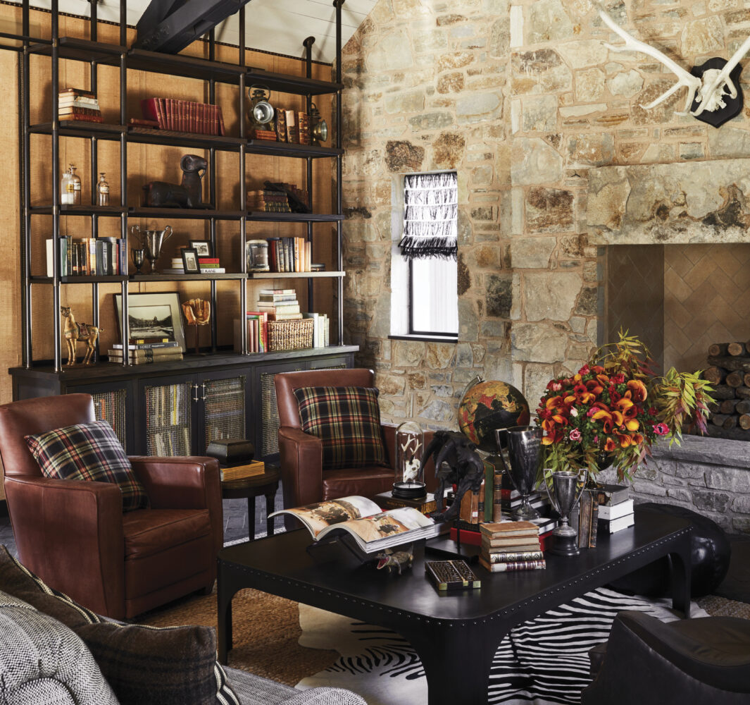 interior of Stewart Cellars with stone wall, leather furniture and bookshelves