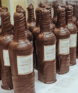 rows of wine bottle shaped chocolate for article Holiday Gift Guide