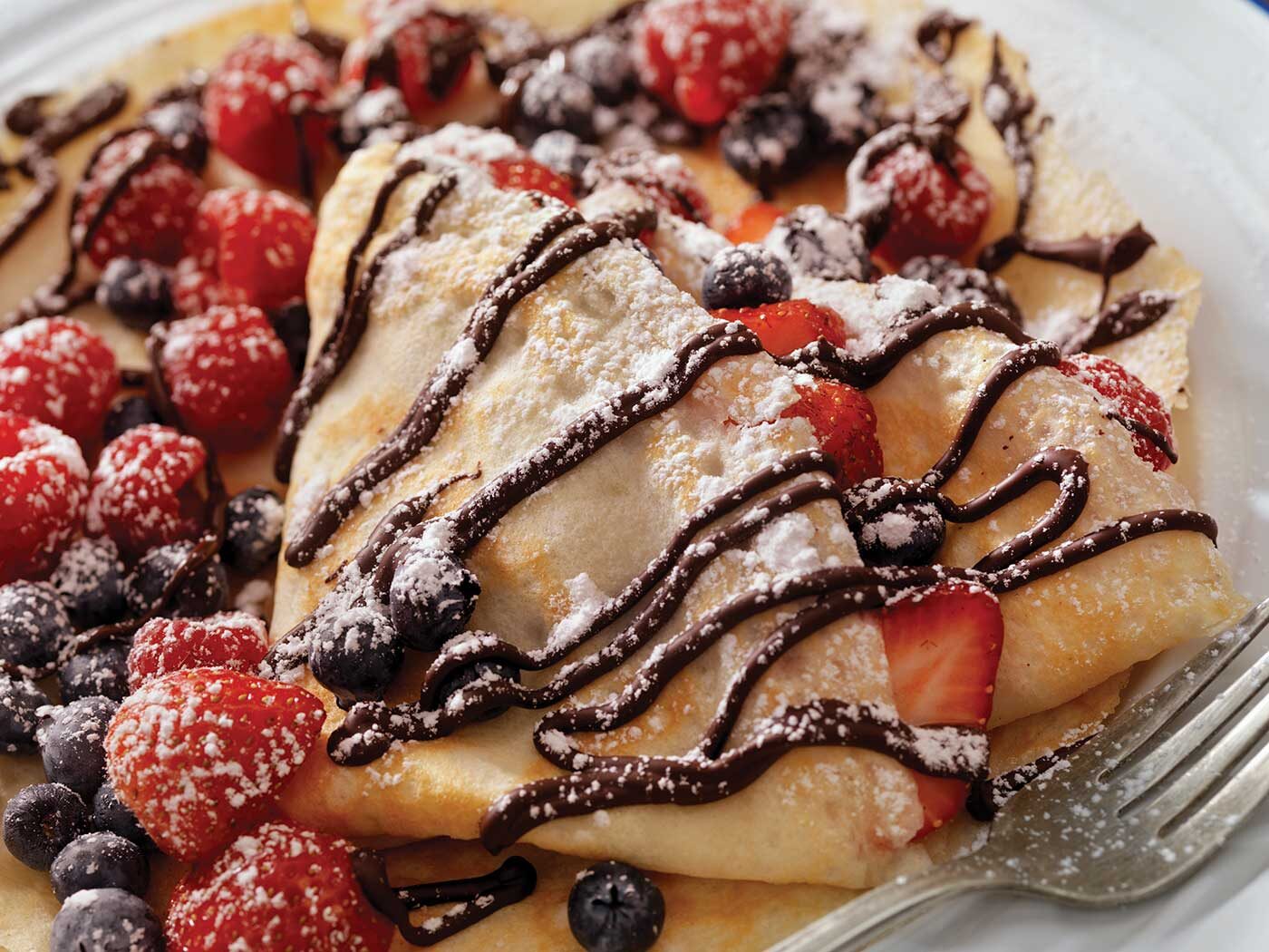 Crépes with berries and chocolate sauce drizzled on top for Karen Crouse article