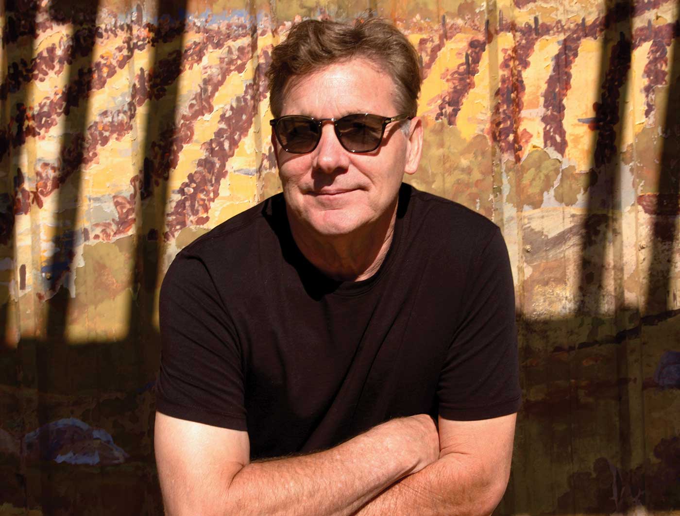 Rex Pickett, seated with arms crossed, wearing sunglasses and black tshirt