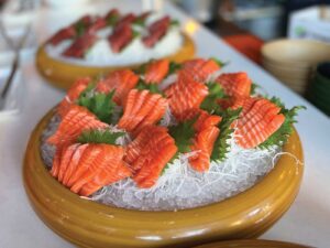 colorful sushi in ice in wood bowl on countertop at Eiko's