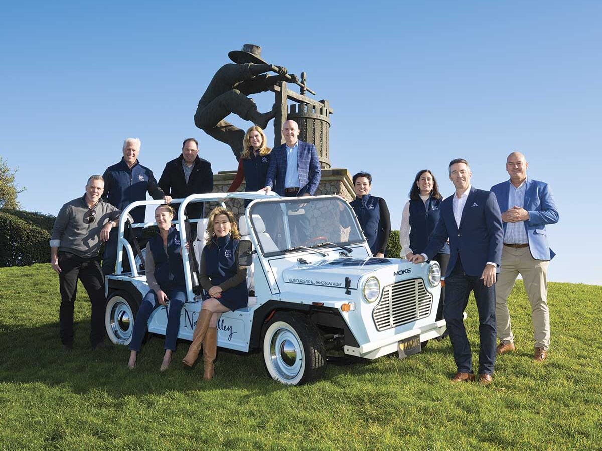hero Visit Napa Valley Board of Directors on and around a white jeep near statue on green field with blue sky