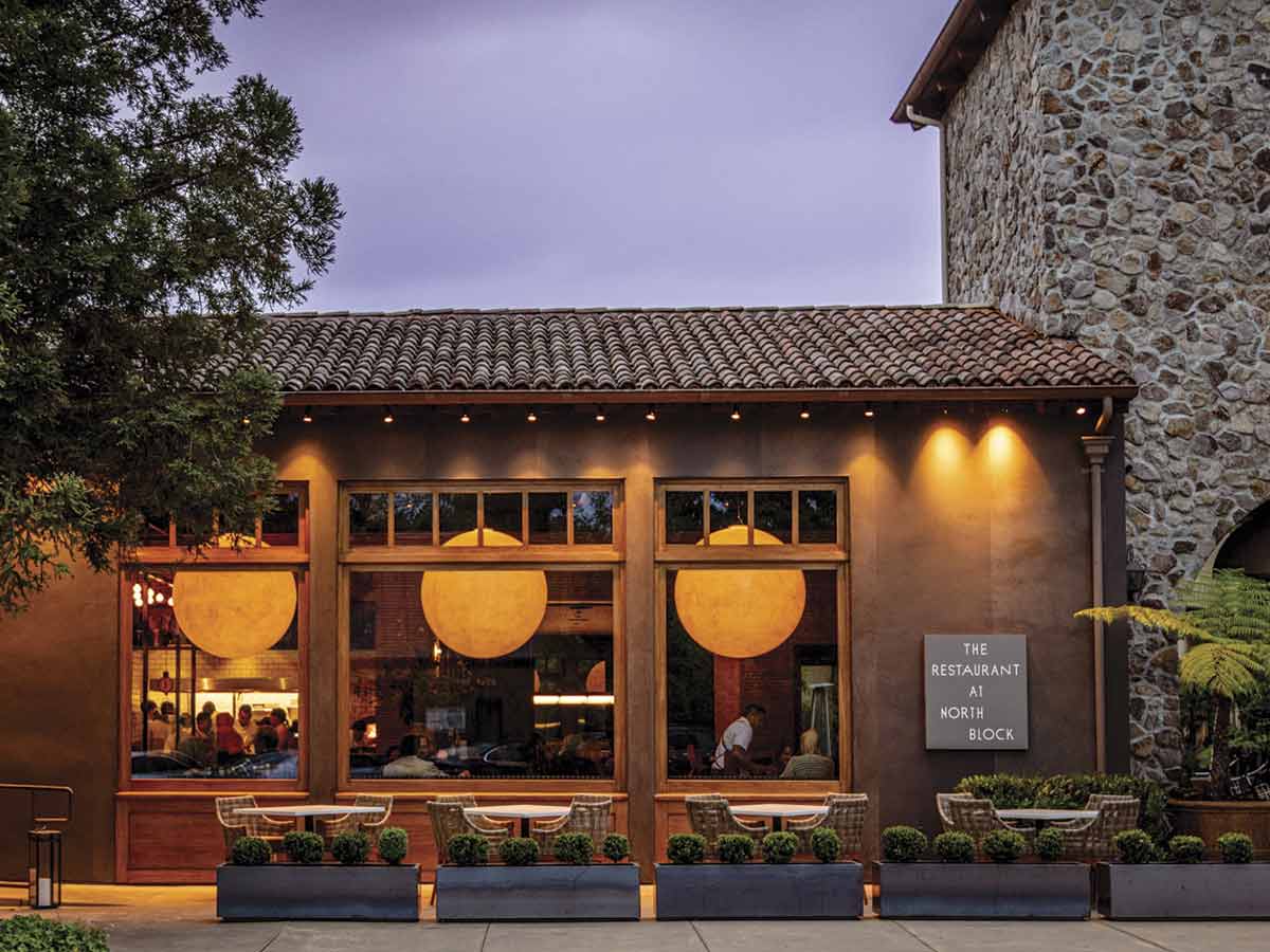 exterior view of The Restaurant at North Block at dusk with lights on