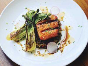 white plate with salmon, bok choi and soy glaze at Eiko's in Napa