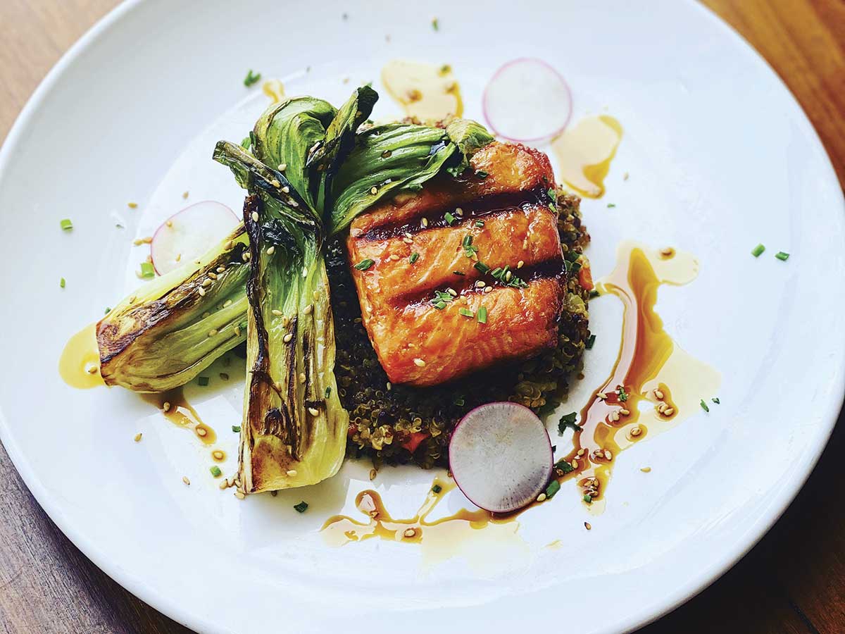 white plate with salmon, bok choi and soy glaze at Eiko's in Napa