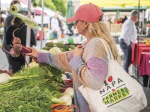 woman holding Napa Farmers Market tote bag