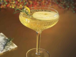 sparkling champagne coupe glass with Rosemary Reverie cocktail for Karen Crouse Napa Valley Signature Sip article