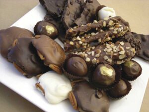 assortment of chocolate treats on a white plate for the Vintage Sweet Shoppe article